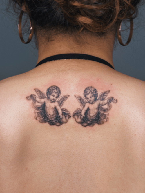black & grey cherubs tattoo — by lunayflorestattoo, los angeles