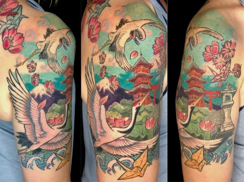 A colorful Japanese-style tattoo featuring a crane, cherry blossoms, and a pagoda on the upper arm — by Sandra Price, los angeles