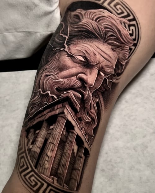 A detailed black and grey realism tattoo of Zeus with a Greek temple on the upper arm, featuring intricate shading and texture — by imindisoul, los angeles