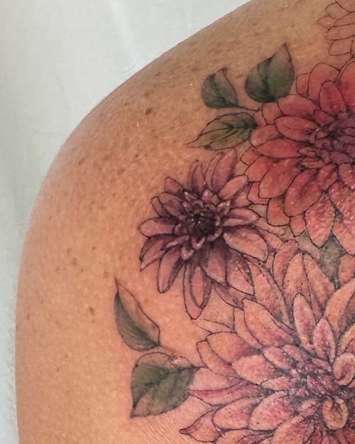 A colorful floral bouquet tattoo on the shoulder with a delicate watercolor style — by Melanie Benoit, los angeles