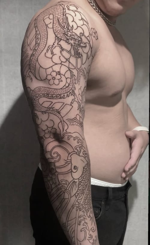 A detailed black and grey Japanese-style dragon tattoo covering the full sleeve with intricate linework and traditional motifs — by Shelby Bianco, los angeles