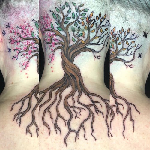 A colorful illustrative tree tattoo on the back, featuring detailed roots and birds, with leaves in various colors — by Sandra Price, los angeles