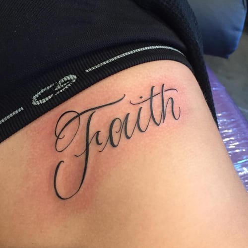 A minimal black script lettering tattoo of the word 'Faith' on the rib — by Johnny Ayala, los angeles