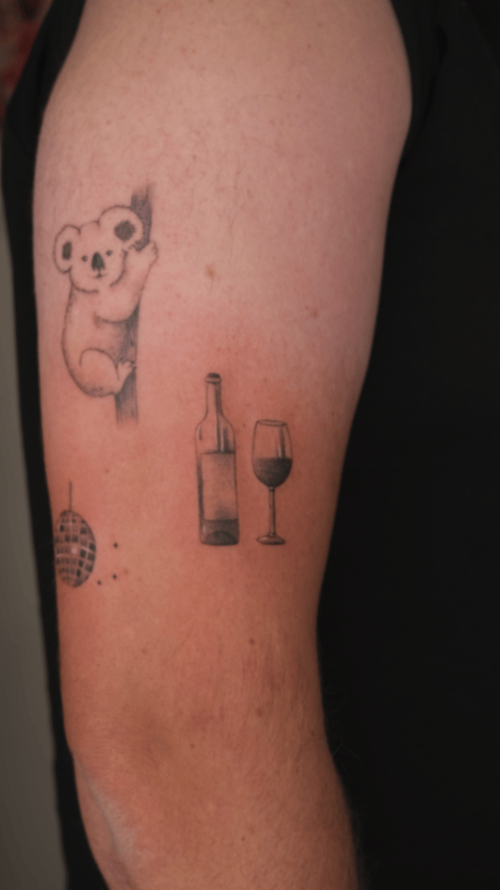 minimalist koala and wine bottle tattoo — by Samantha Wilks, los angeles
