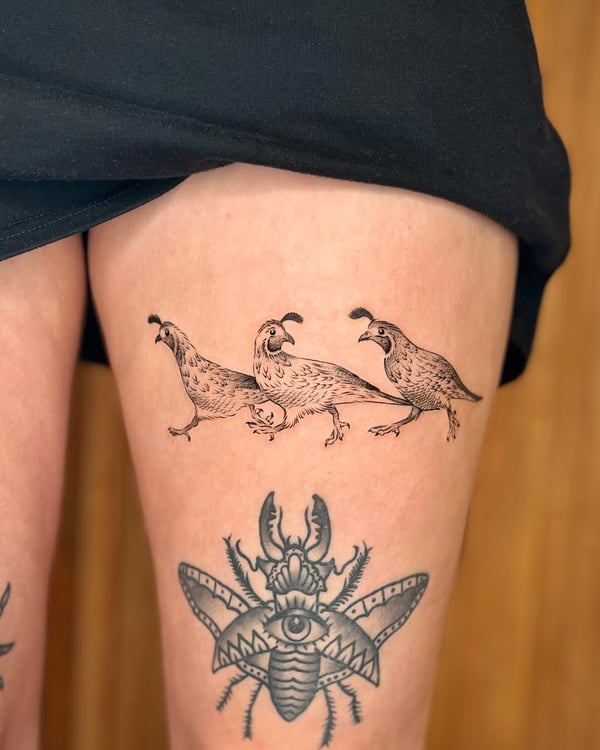 A minimalist blackwork tattoo of three quails on the thigh, featuring clean linework — by Dylan Aiello, los angeles