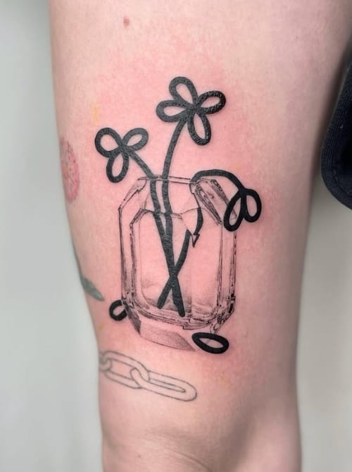 A minimalist black and grey tattoo of simple line-drawn flowers in a geometric vase on the arm — by Level tattoo, los angeles