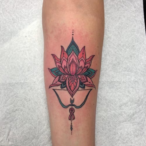 A colorful ornamental lotus flower tattoo on the forearm with intricate linework and delicate details — by Sandra Price, los angeles