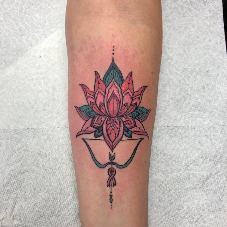 A colorful ornamental lotus flower tattoo on the forearm with intricate linework and delicate details — by Sandra Price, los angeles