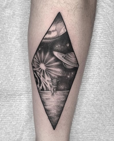 black & grey astronaut on a planet tattoo — by Vince Espinoza, los angeles
