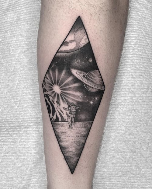 black & grey astronaut on a planet tattoo — by Vince Espinoza, los angeles
