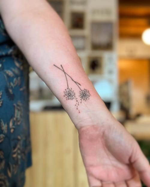 A delicate fine line dandelion tattoo on the forearm, featuring minimalist black ink design — by Dylan Aiello, los angeles