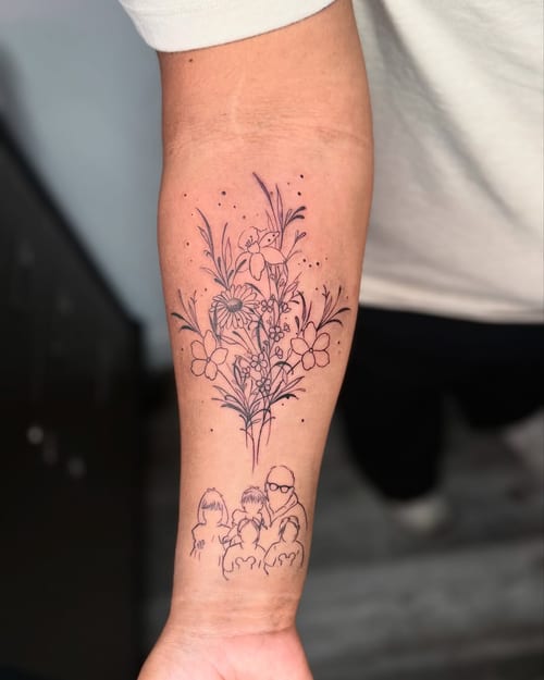 A delicate black and grey fine line tattoo on the forearm featuring a family portrait and a floral bouquet — by zealous, los angeles