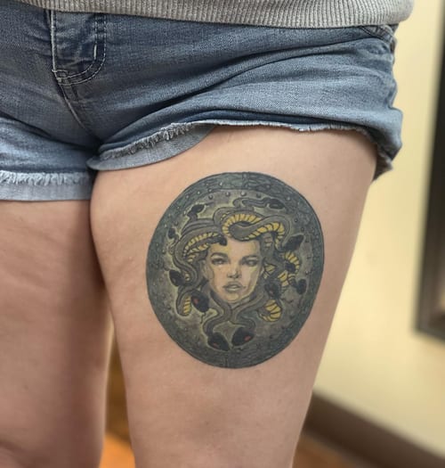 A colorful neo-traditional Medusa tattoo on the thigh, featuring snakes and an ornate design — by Sandra Price, los angeles