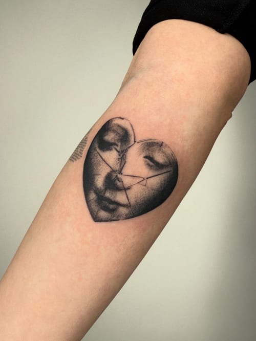 blackwork cracked face in heart tattoo — by Level tattoo, los angeles