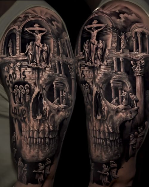 A detailed black and grey tattoo of a skull with a religious scene featuring Jesus on the cross, covering the arm — by Vladimir Kozachenko, los angeles