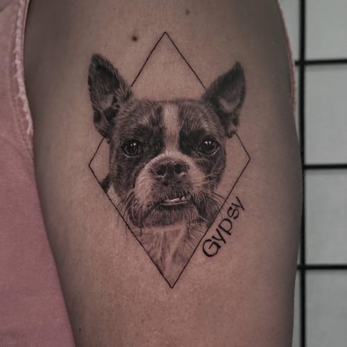 A realistic black and grey dog portrait with geometric elements on the arm, featuring detailed fur texture — by Miguel ANGELO, los angeles
