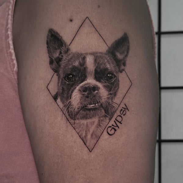 A realistic black and grey dog portrait with geometric elements on the arm, featuring detailed fur texture — by Miguel ANGELO, temecula, ca