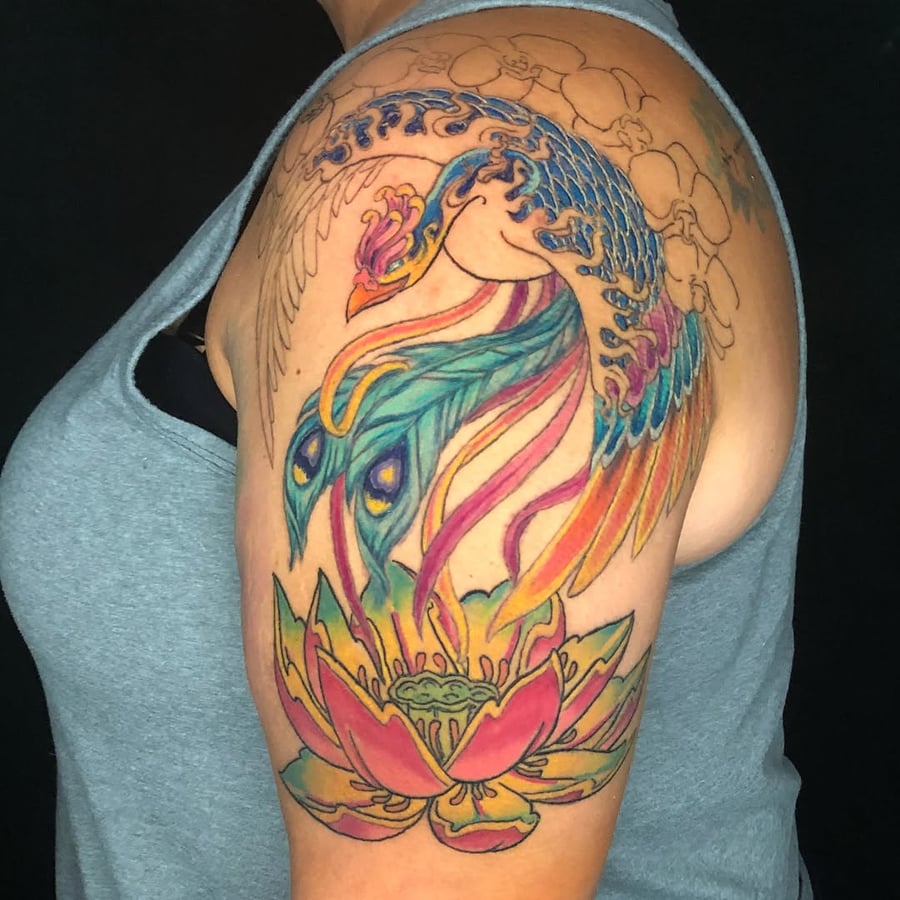 A vibrant color tattoo of a phoenix and lotus on the upper arm, featuring bold Japanese style and intricate details — by Sandra Price, los angeles