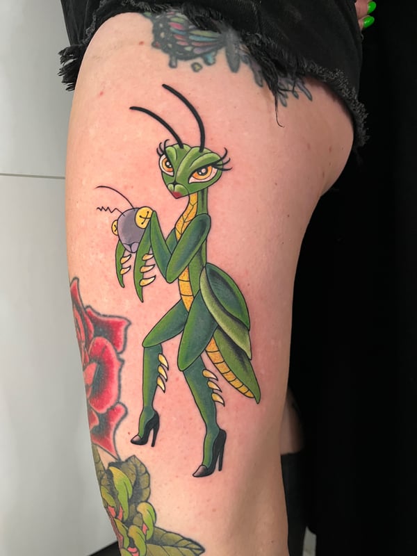 A colorful New School tattoo of a stylized praying mantis wearing high heels on the thigh, featuring bold outlines and vibrant colors — by Megan Rose, long beach, ca