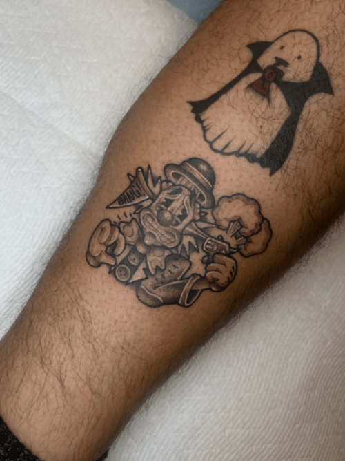 cartoon gangster in a bowler hat firing a revolver with a bang burst and smoke cloud, shin tattoo — by Engram, los angeles