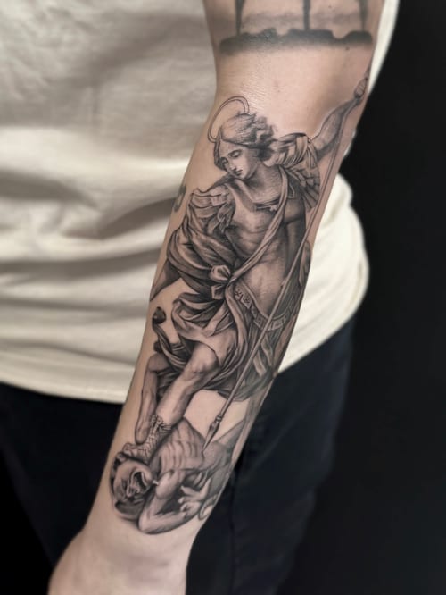 A detailed black and grey realistic depiction of an angel defeating a demon on the forearm, showcasing intricate shading and religious symbolism — by Jian Liang, los angeles
