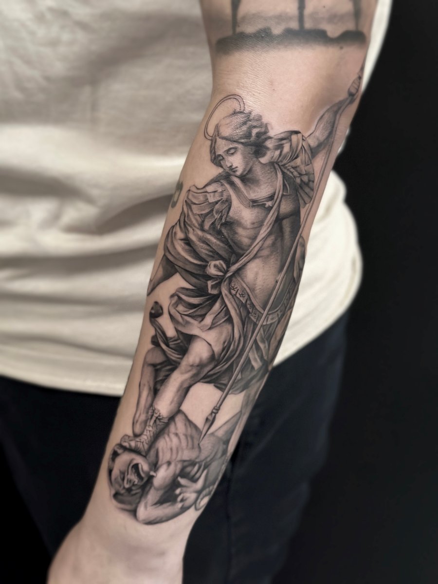 A detailed black and grey realistic depiction of an angel defeating a demon on the forearm, showcasing intricate shading and religious symbolism — by Jian Liang, los angeles