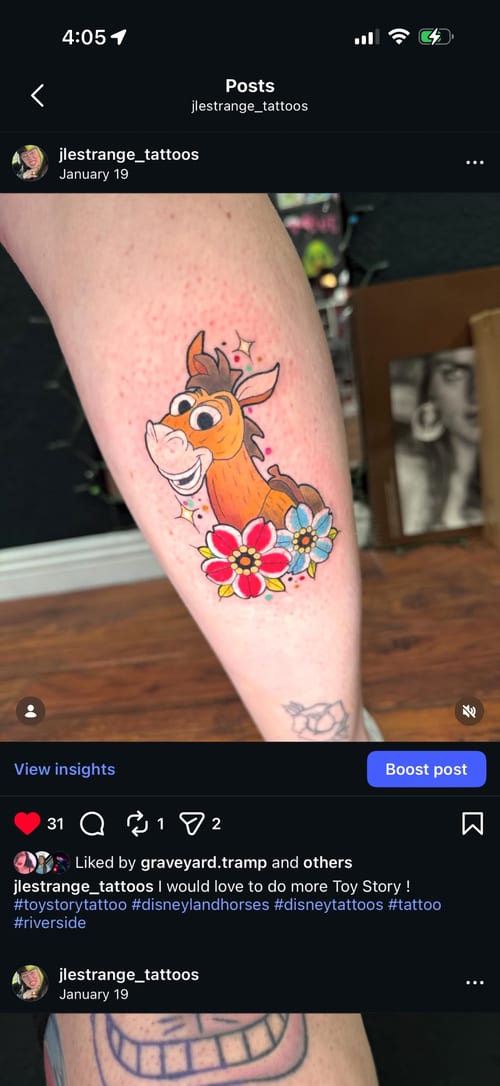 A colorful illustrative tattoo of a cartoon horse surrounded by flowers on the leg, featuring bold outlines and vibrant colors — by Jessica Linden, los angeles