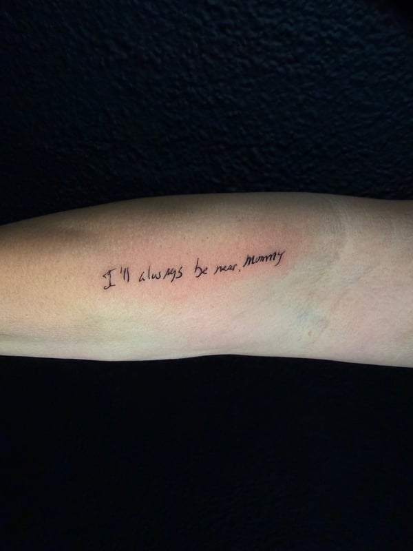 A minimalist black script lettering tattoo on the forearm with a personal quote — by Kiera Garvin, los angeles