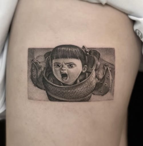 A black and grey realism tattoo of a young girl with pigtails, showing an expressive face, placed on the thigh — by Jian Liang, los angeles
