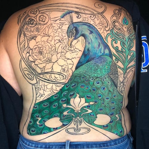A colorful peacock tattoo on the back with intricate ornamental and floral designs, featuring detailed feathers and vibrant colors — by Sandra Price, los angeles