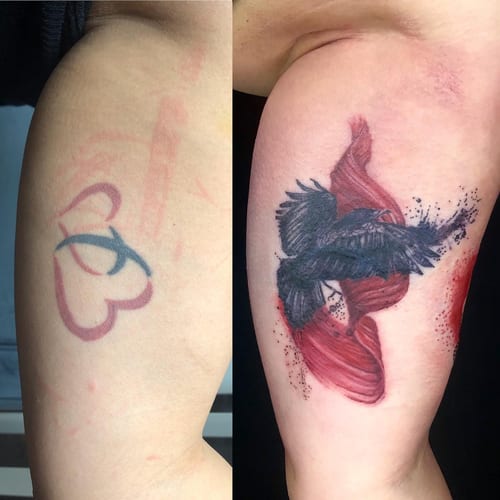 A bold tattoo of a bird in flight with abstract red elements on the upper arm, combining realism and abstract styles — by Sandra Price, los angeles