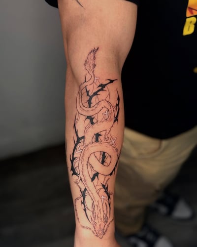 A bold black and grey linework dragon tattoo on the forearm with graphic elements — by zealous, los angeles