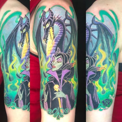 A colorful neo-traditional tattoo of a villain and dragon on the upper arm, featuring bold lines and vibrant colors — by Sandra Price, los angeles