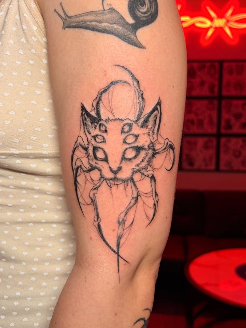 sketchy illustrative blackwork tattoo of a many-eyed cat-spider hybrid by Vince Espinoza, a blackwork tattoo artist in los angeles