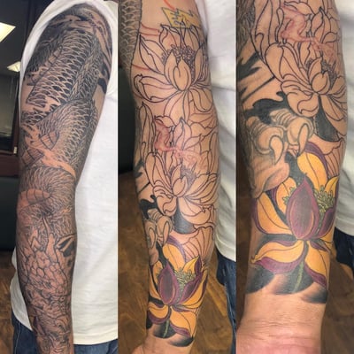 A bold Japanese dragon and flower tattoo sleeve with black and grey shading and colorful floral elements — by Sandra Price, los angeles