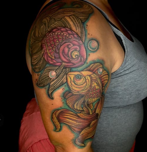 A vibrant neo-traditional tattoo of a koi fish and rose on the upper arm, featuring bold colors and ornate details — by Sandra Price, los angeles