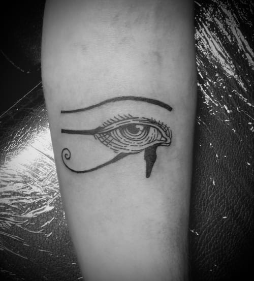 A blackwork line tattoo of an eye on the forearm, featuring bold lines and minimalistic design — by Tag Devilish, los angeles