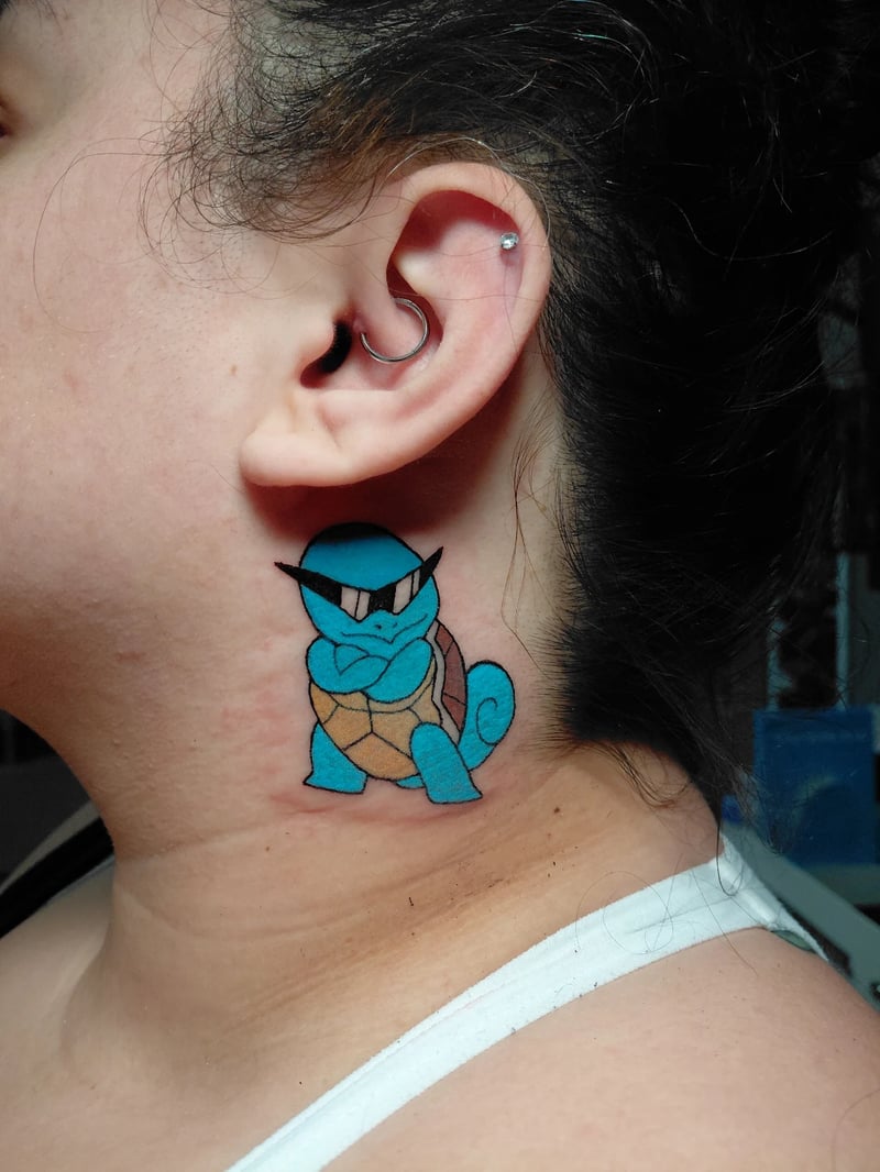 clean color cartoon tattoo of Squirtle wearing sunglasses behind the ear by anoetic.designs, an anime tattoo artist in los angeles
