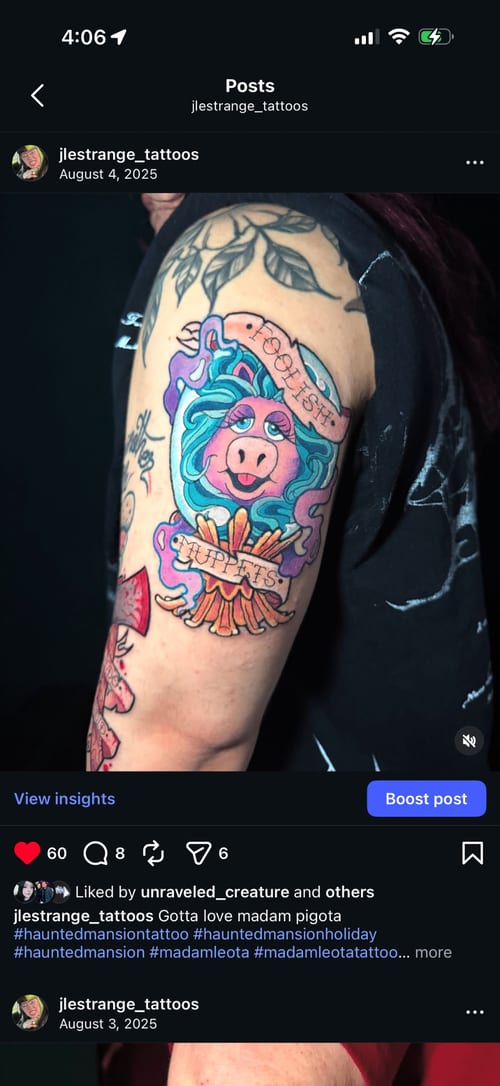 A colorful new school tattoo on the upper arm featuring a cartoon-style pig with vibrant colors and bold outlines, accompanied by script elements — by Jessica Linden, los angeles