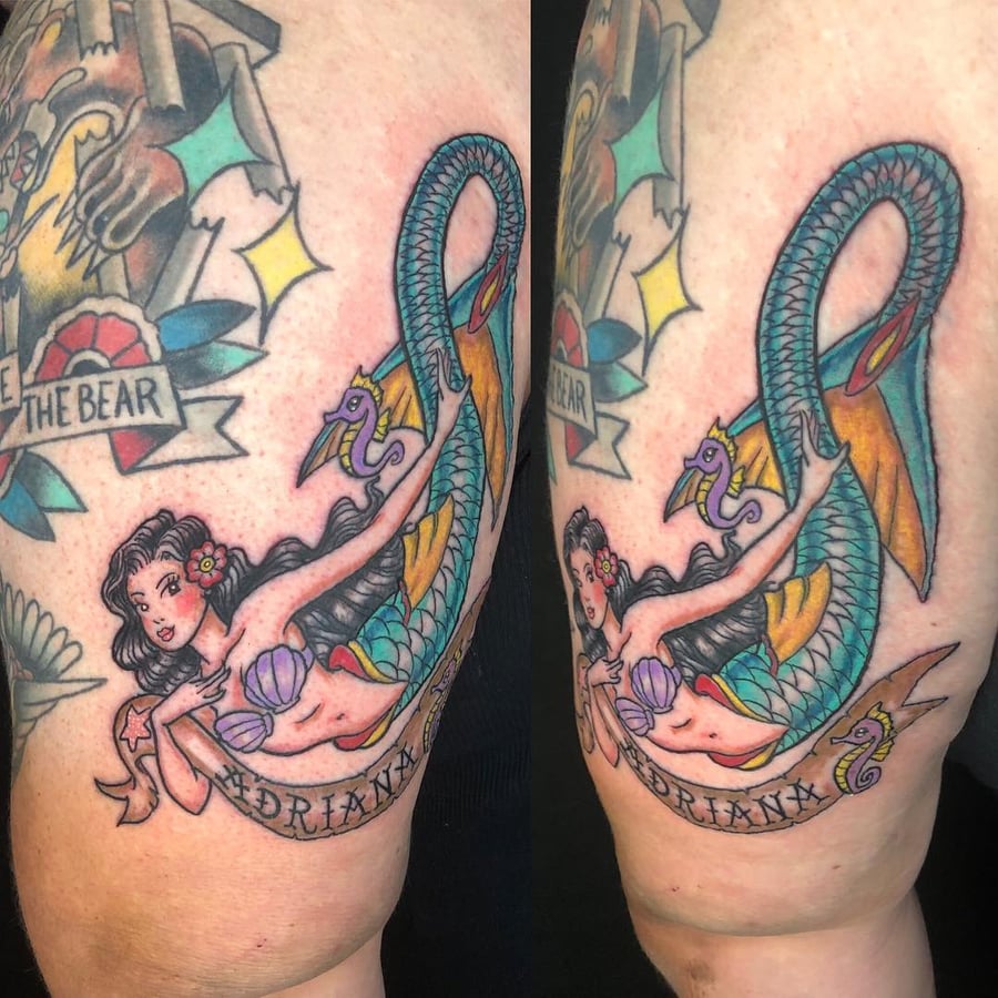 A colorful neo-traditional mermaid tattoo on the arm, featuring a sea serpent and a banner with bold illustrative style — by Sandra Price, los angeles