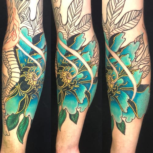 A bold and colorful Japanese-style flower tattoo on the forearm, featuring intricate leaf details and vibrant colors — by Sandra Price, los angeles