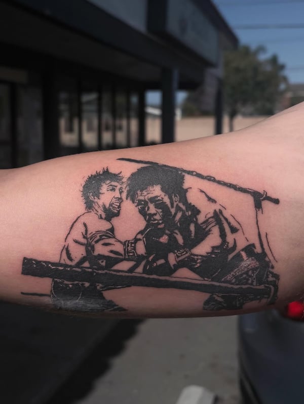 A bold blackwork tattoo depicting two men fighting on the forearm, with strong graphic lines and illustrative style — by Hannah , fountain valley, ca