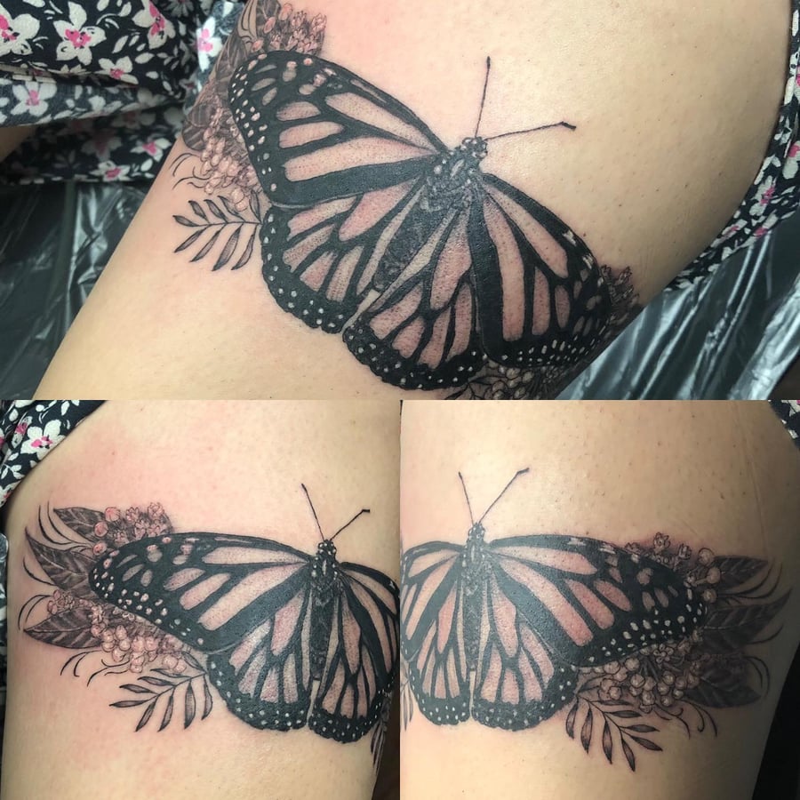 A black and grey butterfly tattoo with floral elements on the thigh, featuring delicate and ornate illustrative details — by Sandra Price, los angeles
