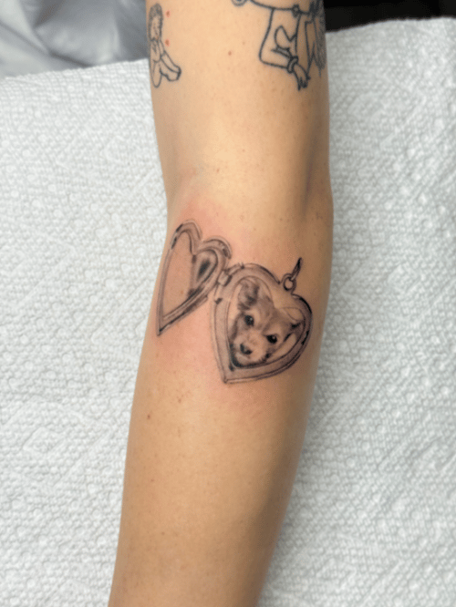 realism dog in heart locket tattoo — by lunayflorestattoo, los angeles