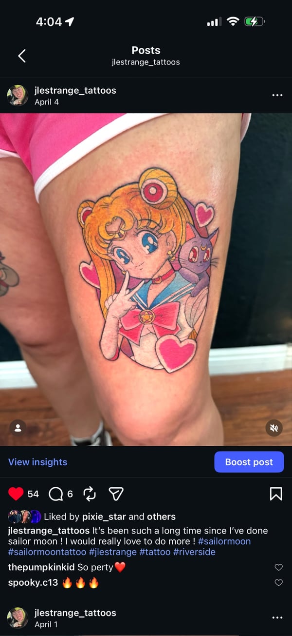 A colorful anime-style tattoo of Sailor Moon with hearts on the thigh, featuring vibrant colors and bold outlines — by Jessica Linden, riverside, ca