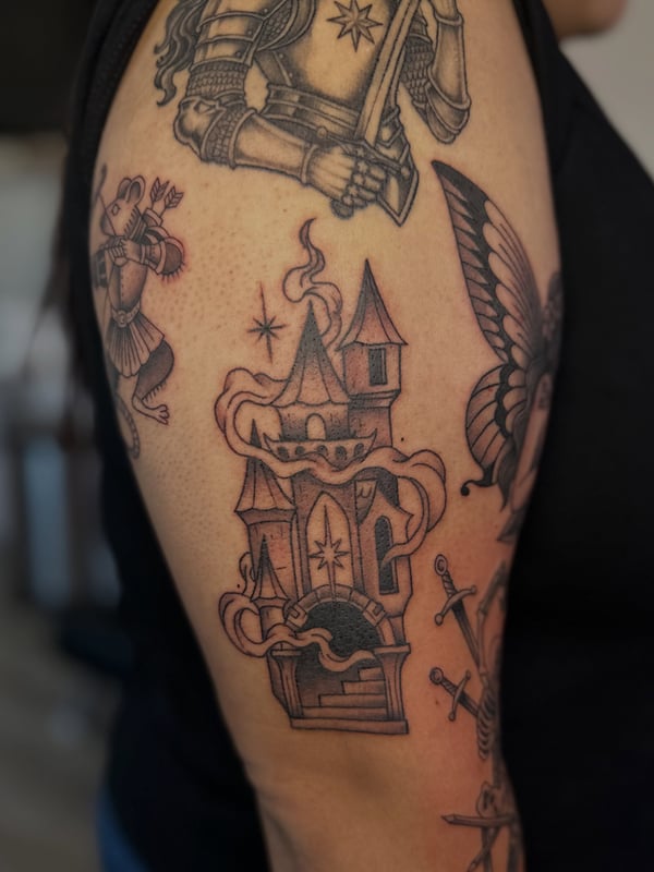 A traditional black and grey medieval castle with smoke on the upper arm — by Maddie Ramirez, palm desert, ca