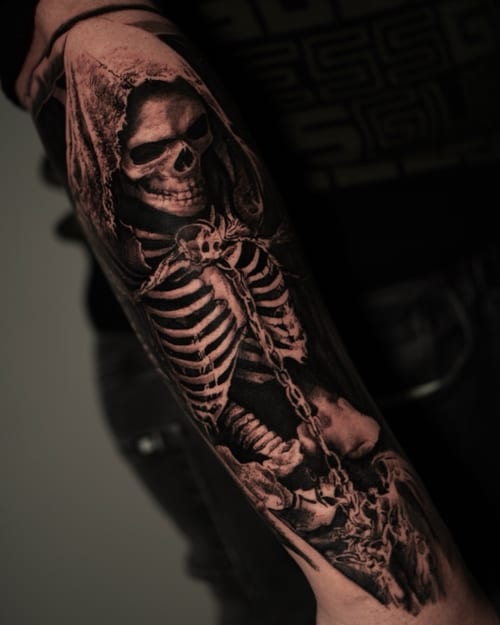 A realistic black and grey tattoo of a skeleton in a hood on the forearm, featuring detailed shading and a dark theme — by Vladimir Kozachenko, los angeles