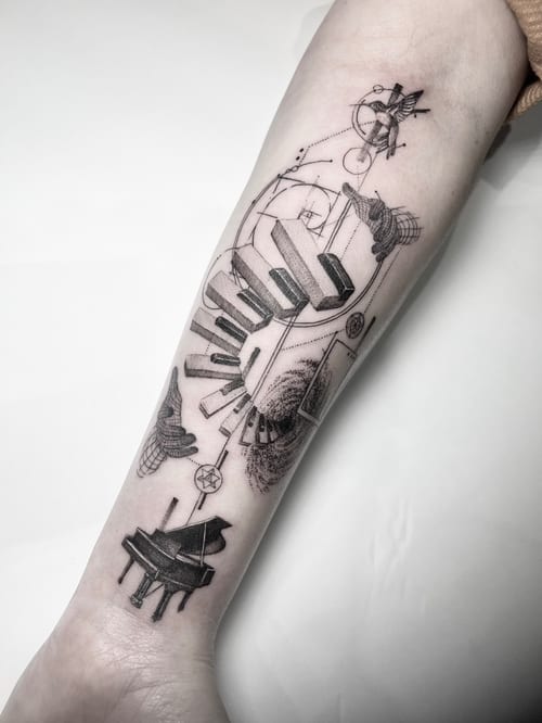 A black and grey abstract tattoo of a piano with linework and dotwork details on the forearm — by INKEDBy_G, los angeles