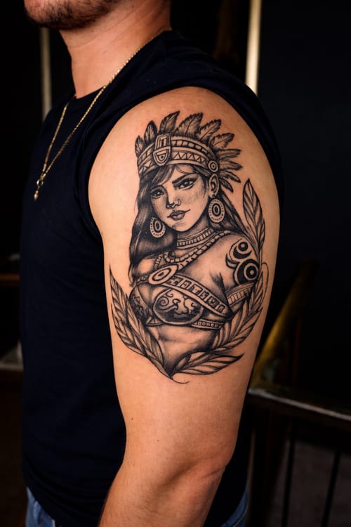 A black and grey portrait of a woman with tribal elements on the upper arm, featuring detailed shading and intricate patterns — by Edgar Armas Rodriguez, los angeles