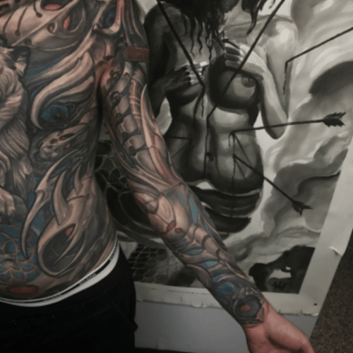 A mixed color and black and grey bio-mechanical full sleeve tattoo featuring abstract elements and a woman's figure with arrows — by tyler_whitlock, los angeles